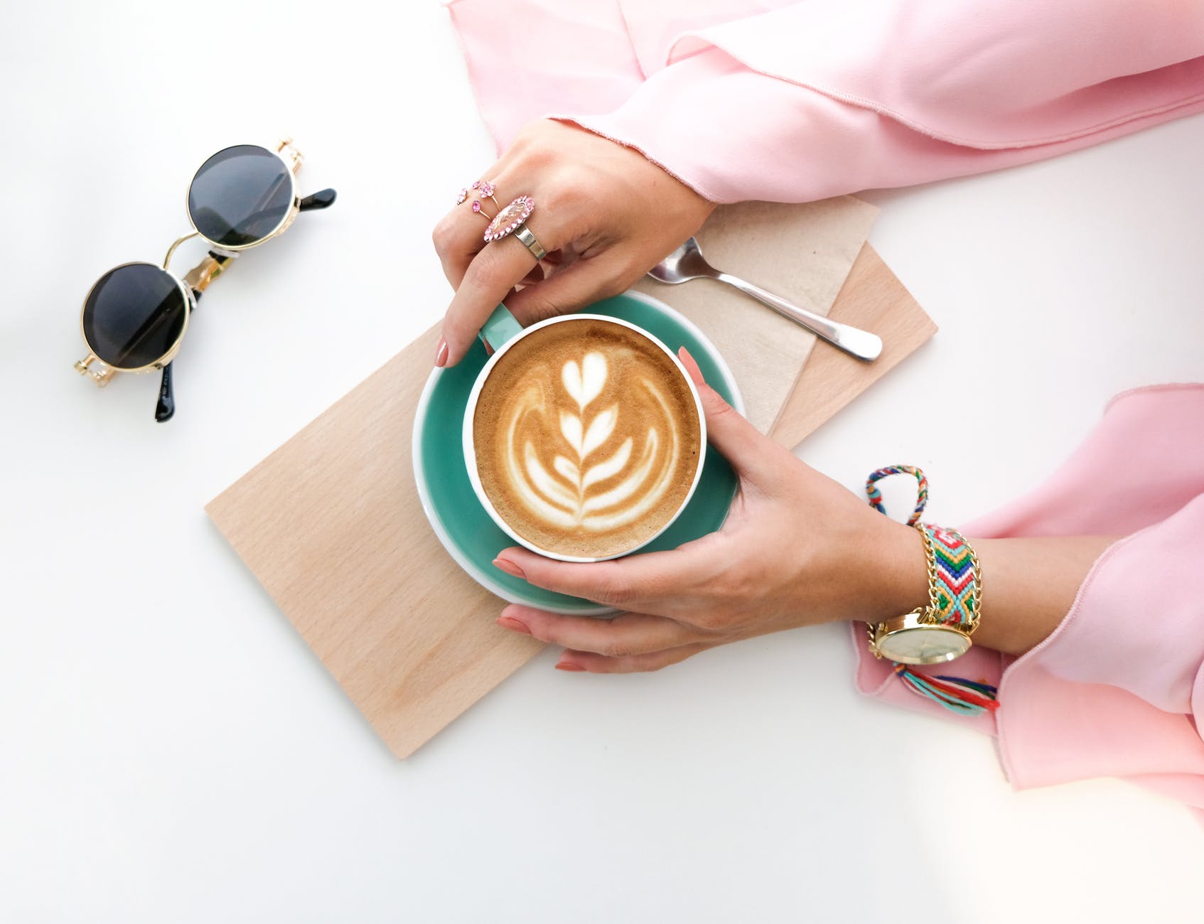 woman holding cup of latte